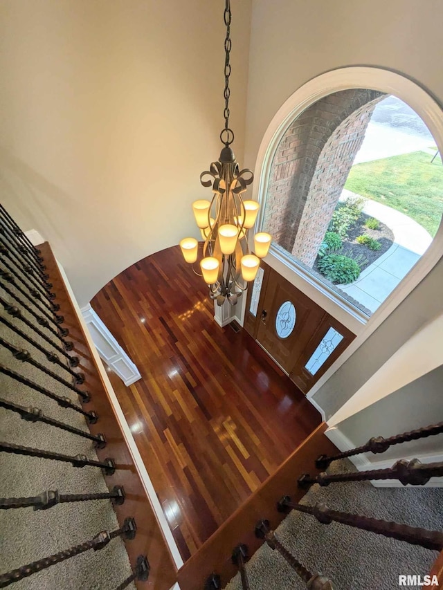 interior details featuring a chandelier and hardwood / wood-style floors