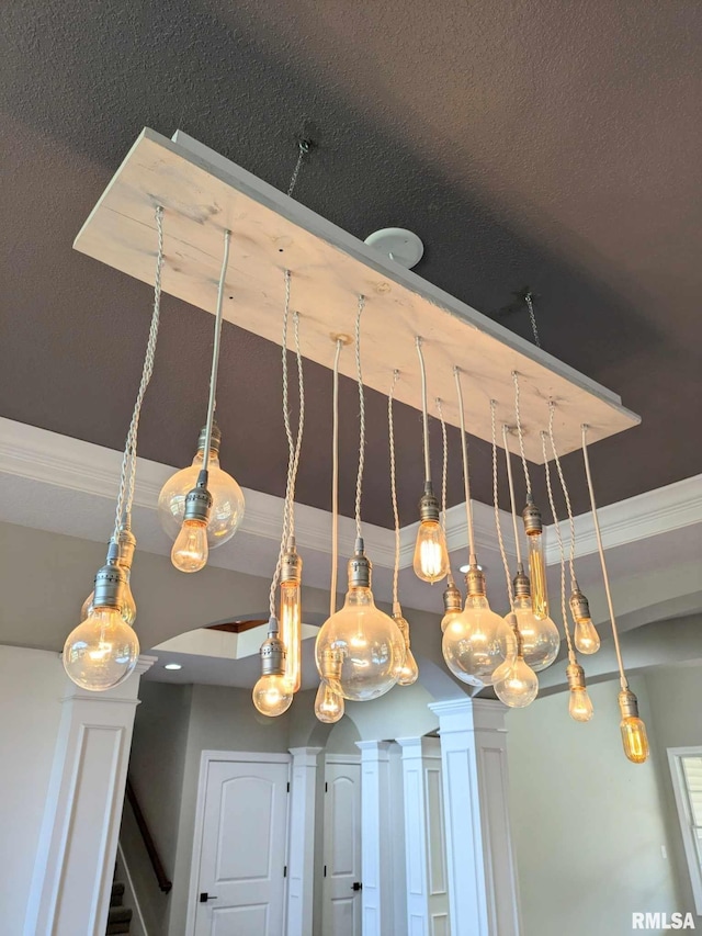 details featuring a textured ceiling and ornamental molding