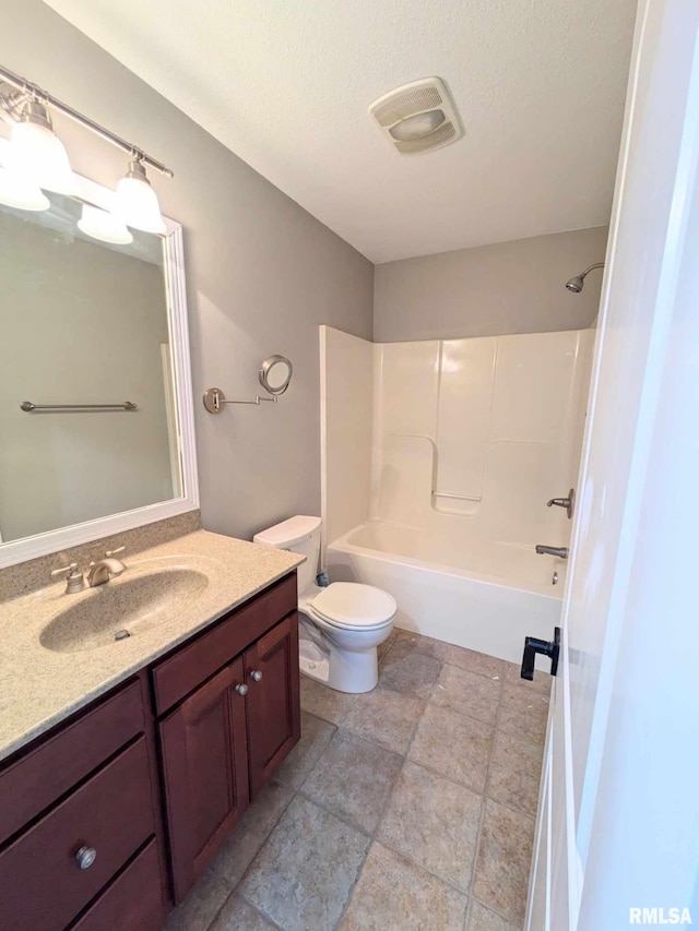 full bathroom featuring vanity, shower / bathtub combination, toilet, and a textured ceiling