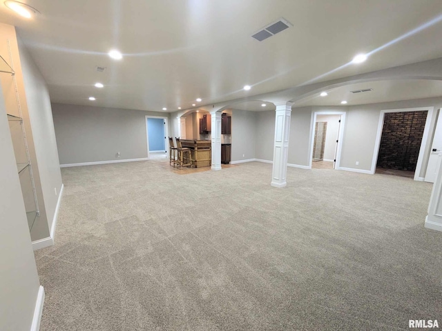 basement with light carpet and a fireplace