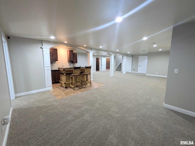 carpeted living room with bar area