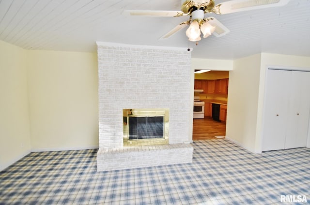 unfurnished living room with ceiling fan and a brick fireplace