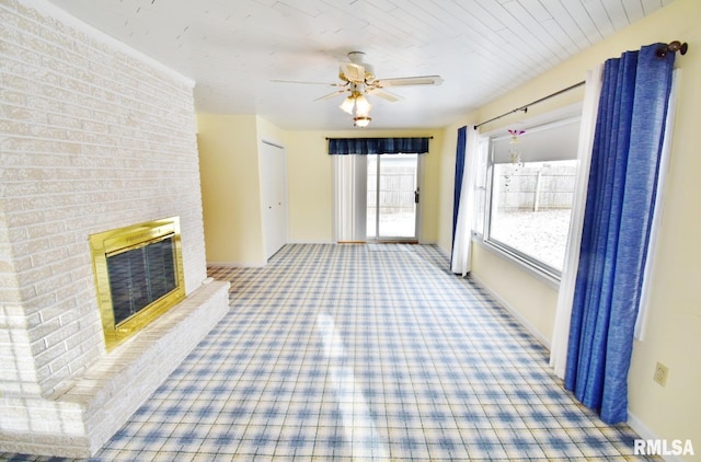 unfurnished living room featuring a fireplace and ceiling fan