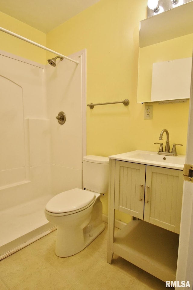 bathroom with a shower, tile patterned floors, vanity, and toilet