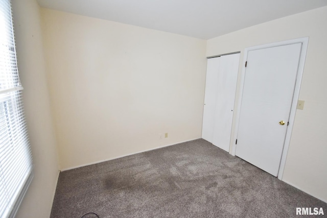 unfurnished bedroom with multiple windows and carpet