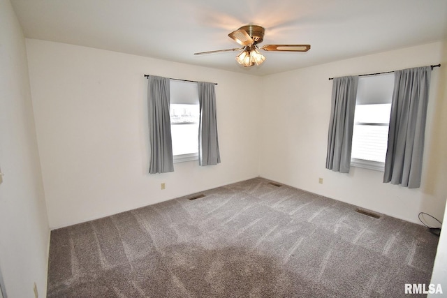 spare room featuring carpet floors and ceiling fan