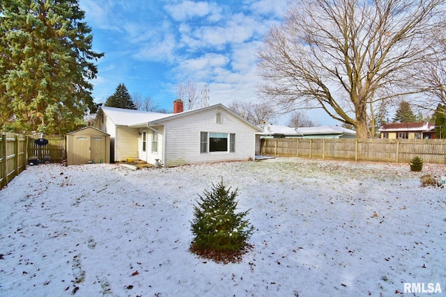 snow covered house with a storage shed