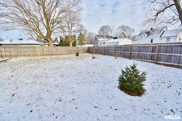 view of yard layered in snow