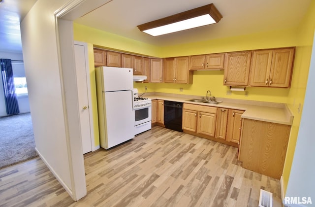 kitchen with white appliances, sink, and light hardwood / wood-style flooring