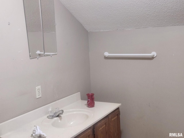 bathroom with vanity and a textured ceiling