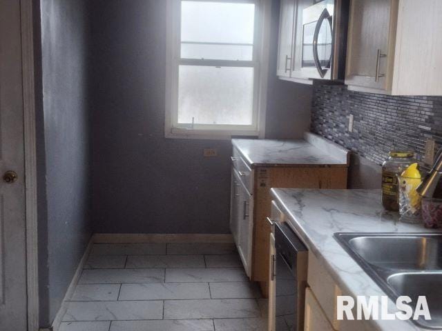 kitchen with decorative backsplash, sink, and appliances with stainless steel finishes