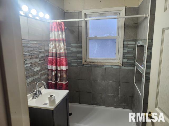 bathroom with vanity and walk in shower