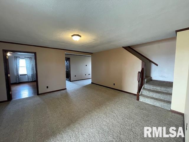 unfurnished living room with carpet and a textured ceiling