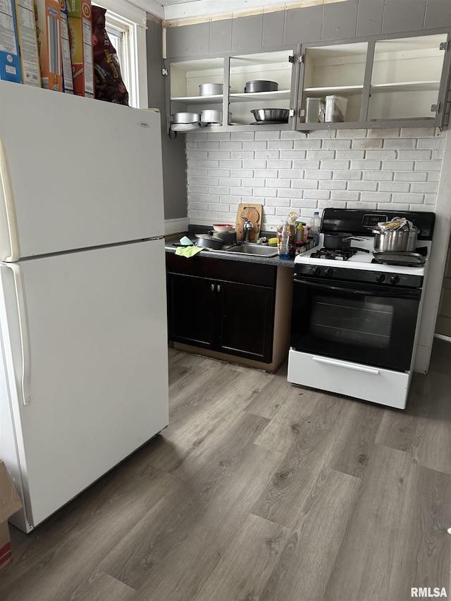 kitchen featuring sink, white appliances, and light hardwood / wood-style flooring