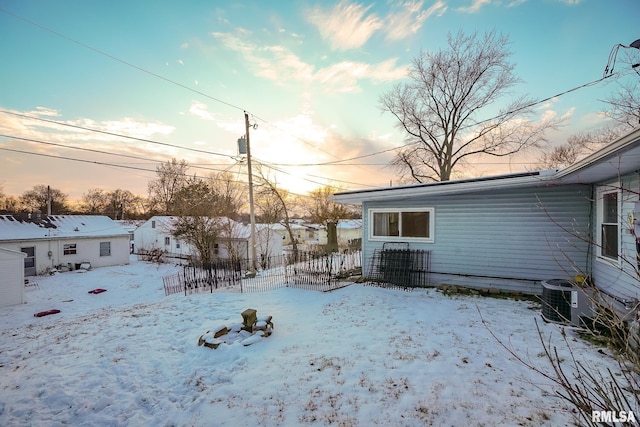 yard covered in snow featuring central air condition unit