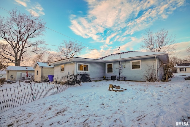 view of snow covered back of property