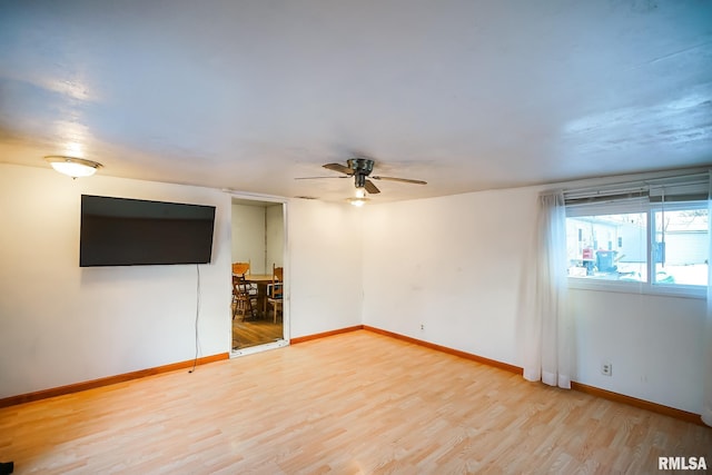 spare room with ceiling fan and wood-type flooring