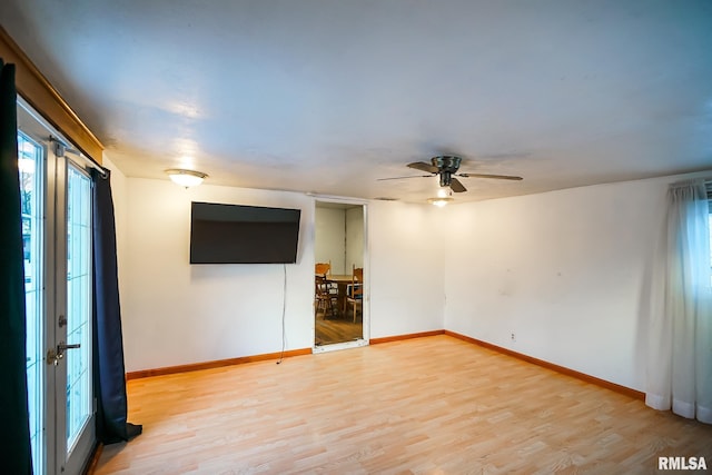 empty room with ceiling fan and light hardwood / wood-style floors