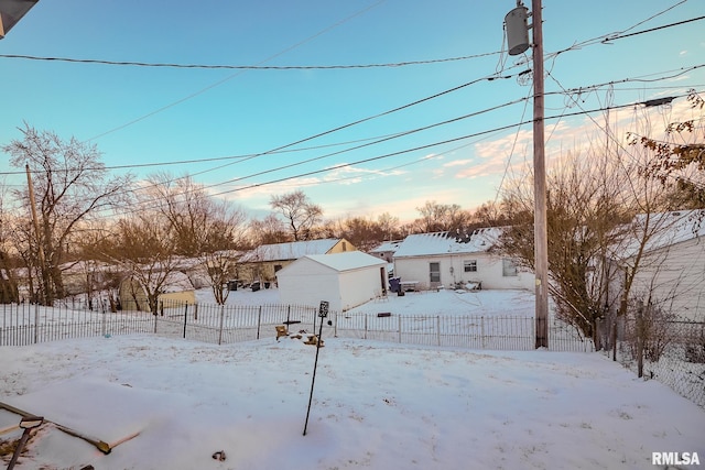 yard layered in snow with an outdoor structure