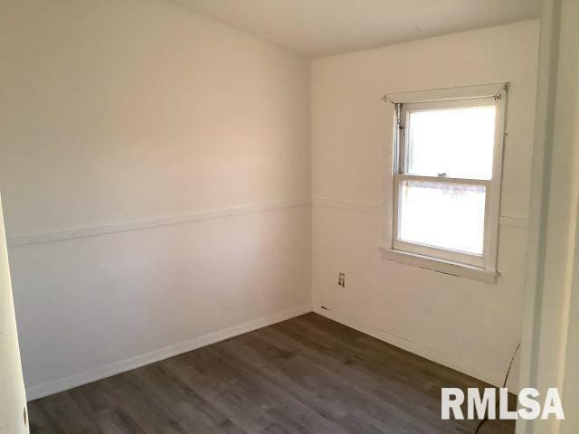 spare room featuring dark hardwood / wood-style flooring