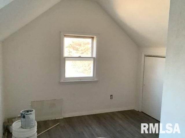 bonus room featuring dark hardwood / wood-style flooring and vaulted ceiling