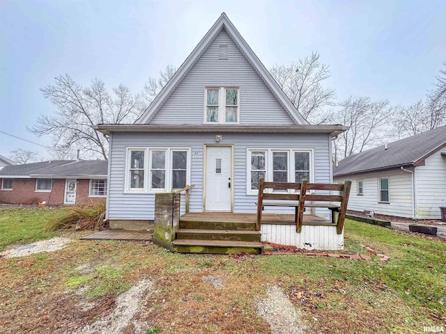 rear view of house featuring a yard