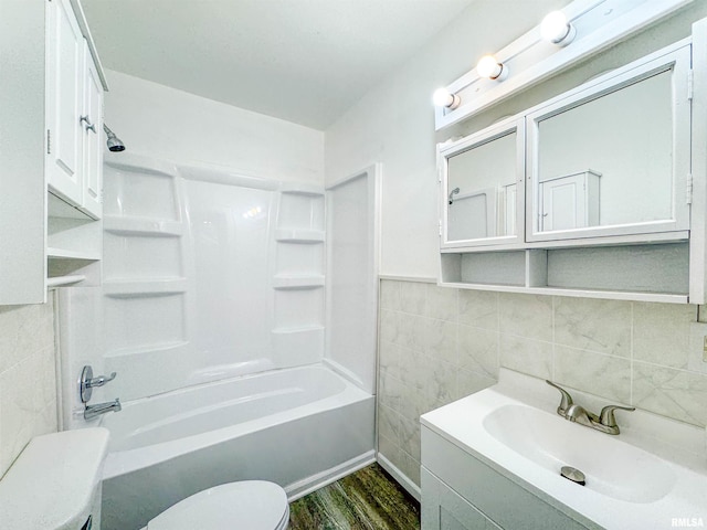 full bathroom with shower / bathing tub combination, vanity, toilet, tile walls, and wood-type flooring