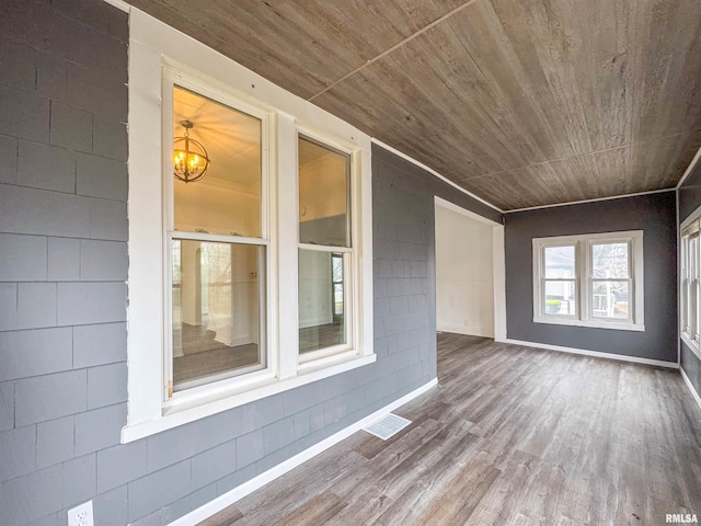 interior space with hardwood / wood-style flooring and an inviting chandelier