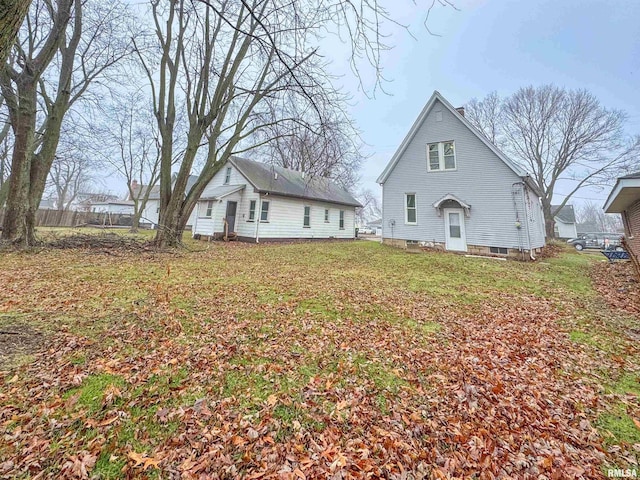 rear view of property featuring a yard