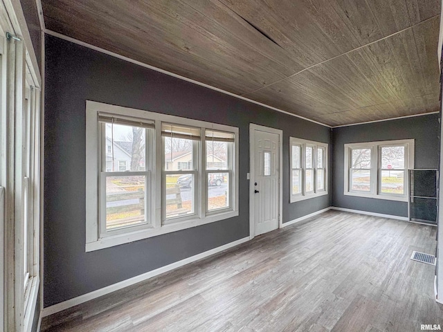 unfurnished sunroom featuring plenty of natural light and wood ceiling