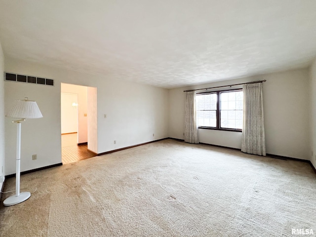 empty room featuring light colored carpet