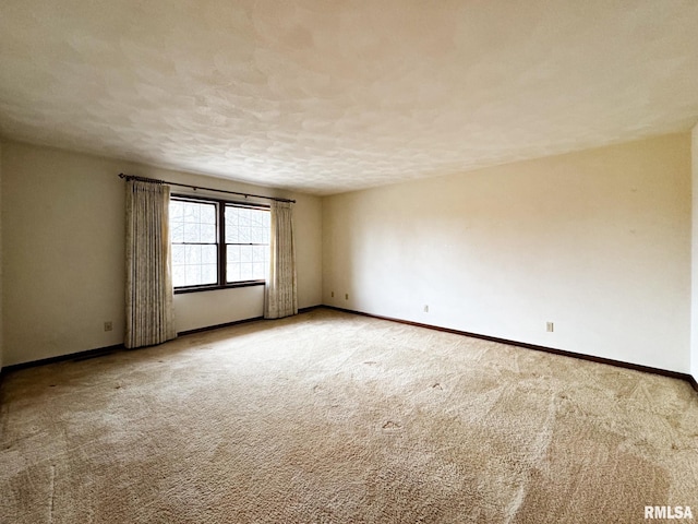 unfurnished room featuring a textured ceiling and carpet floors