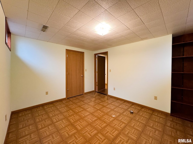 unfurnished room with light parquet flooring