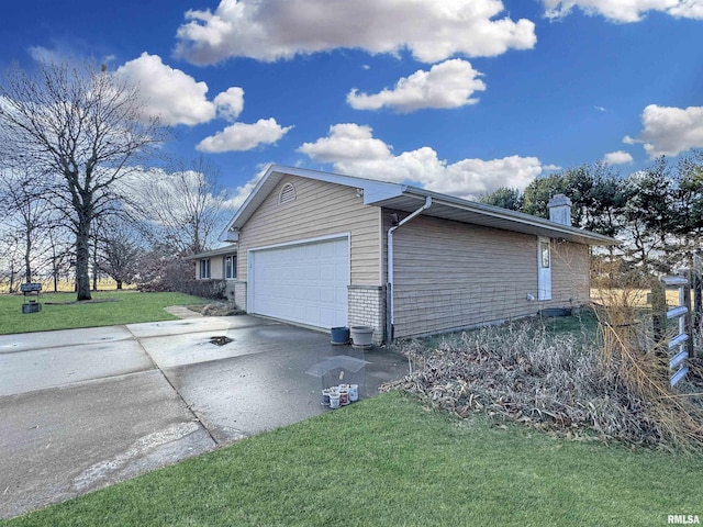 view of side of property with a lawn and a garage