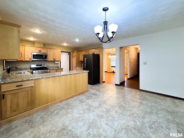 kitchen with kitchen peninsula, hanging light fixtures, sink, an inviting chandelier, and stainless steel appliances