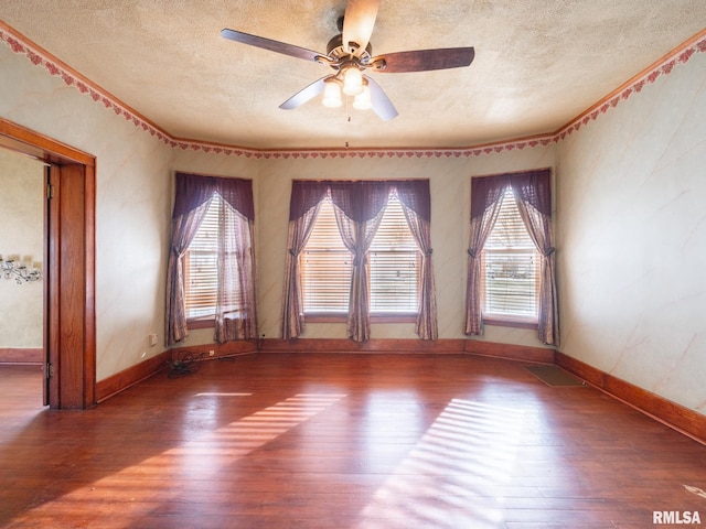 unfurnished room with ceiling fan, hardwood / wood-style floors, and a textured ceiling