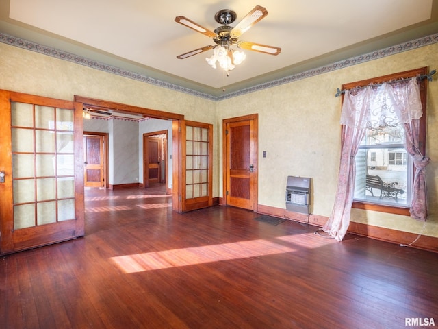 spare room with french doors, heating unit, ceiling fan, and dark wood-type flooring