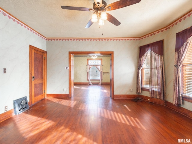 unfurnished living room with a textured ceiling, hardwood / wood-style flooring, and ceiling fan