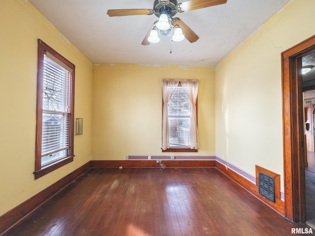 unfurnished room with ceiling fan and dark hardwood / wood-style floors