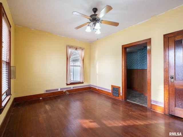 unfurnished bedroom with ceiling fan and dark hardwood / wood-style flooring