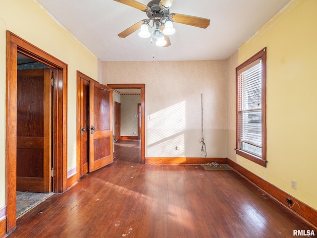 spare room with ceiling fan and dark hardwood / wood-style flooring