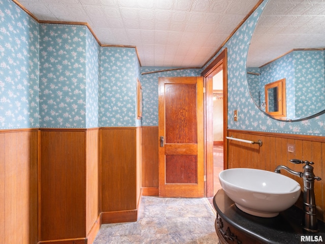 bathroom with wood walls and vanity