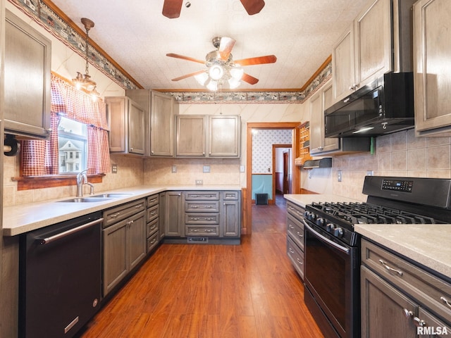 kitchen with ceiling fan, sink, stainless steel appliances, dark hardwood / wood-style floors, and decorative light fixtures