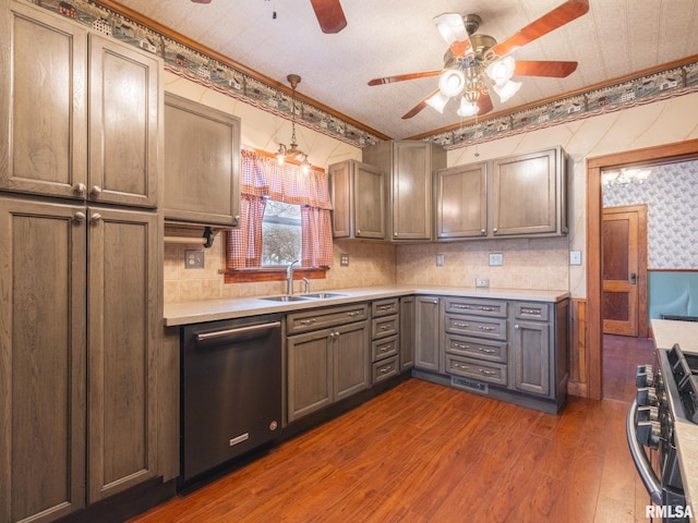 kitchen featuring pendant lighting, ornamental molding, sink, and appliances with stainless steel finishes