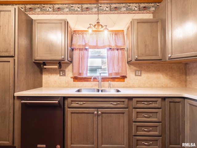 kitchen with sink, tasteful backsplash, stainless steel dishwasher, pendant lighting, and a chandelier