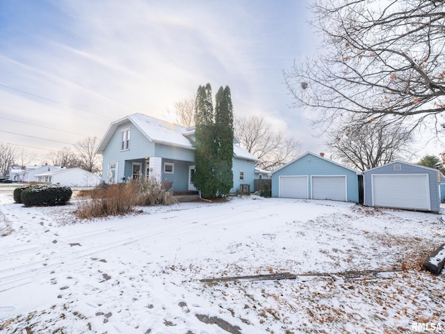 view of front of home with a garage and an outbuilding