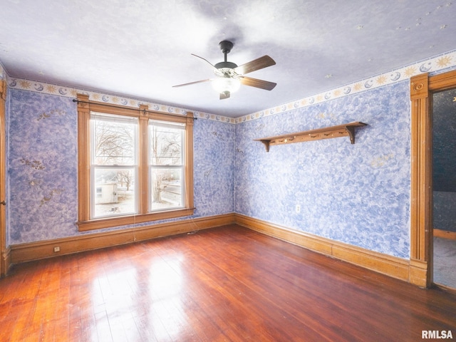 empty room featuring ceiling fan and hardwood / wood-style floors