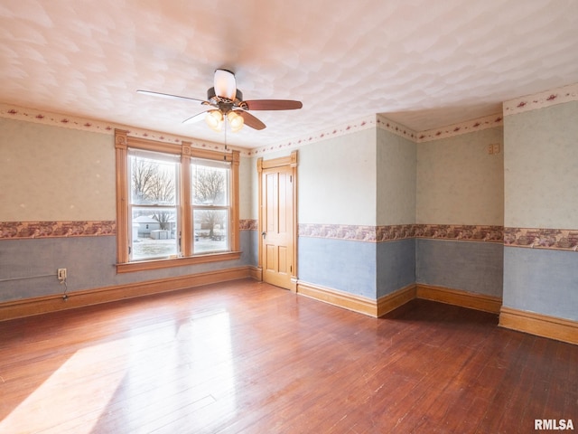 unfurnished room with ceiling fan and hardwood / wood-style floors