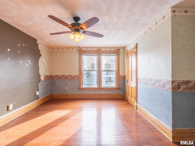 unfurnished room featuring hardwood / wood-style floors and ceiling fan