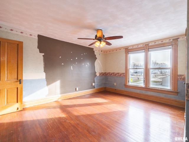 unfurnished room featuring hardwood / wood-style flooring and ceiling fan